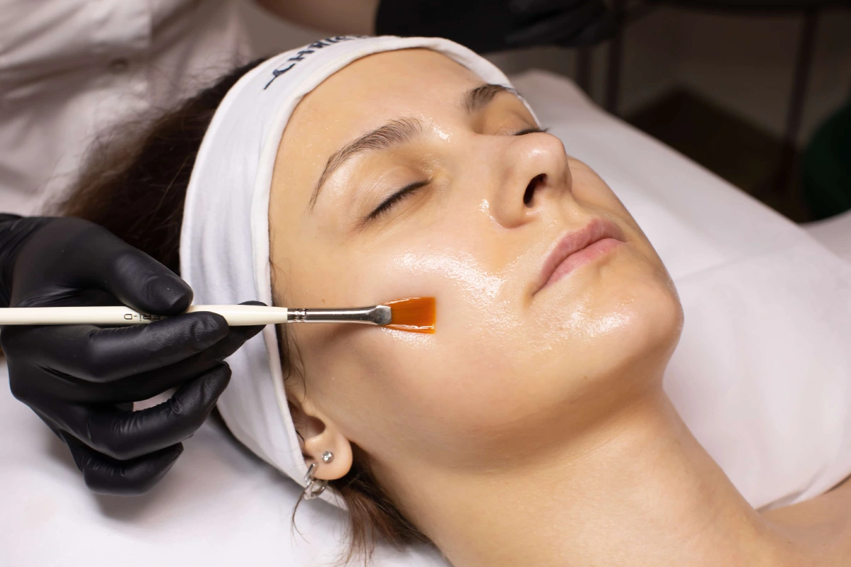 Woman receiving facial exfoliation in Syracuse, NY to improve skin texture and radiance.